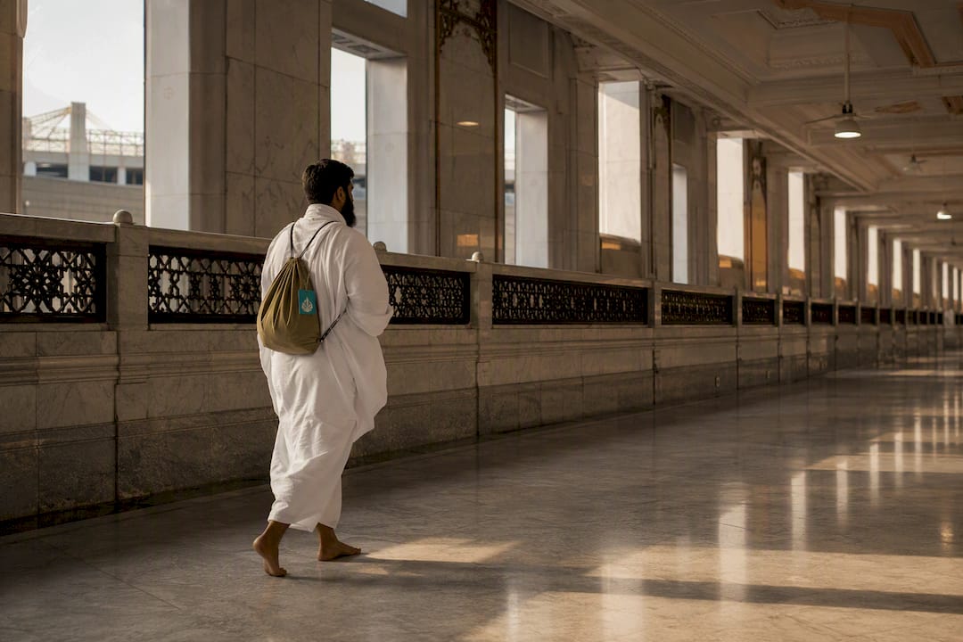 Proxy pilgrim walking through Sa'i gallery