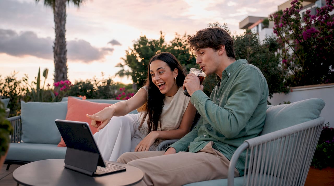 Couple searching homes online on laptop