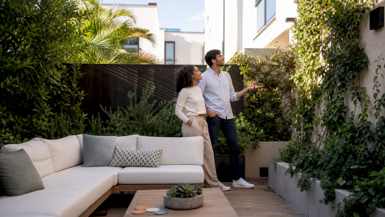 Young couple touring staged living room
