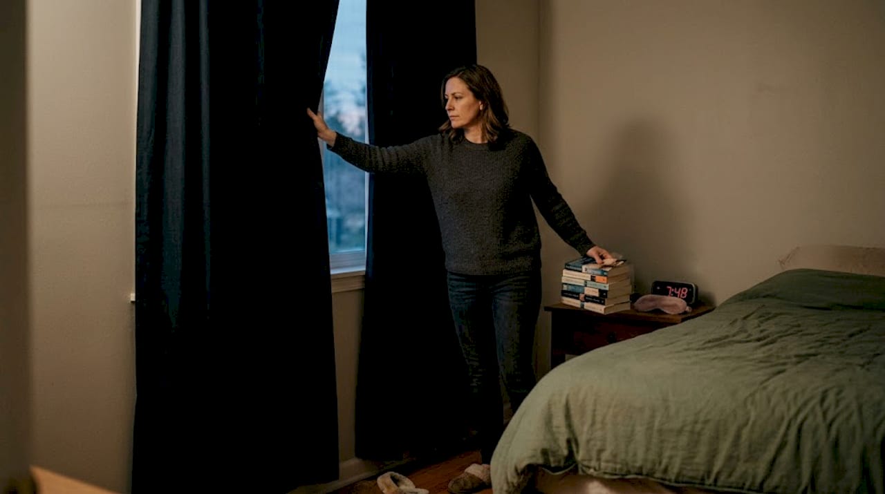 Woman setting up restful bedroom atmosphere