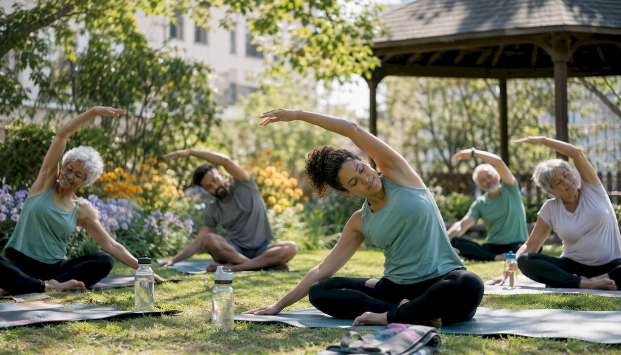 People stretching in community park exercise