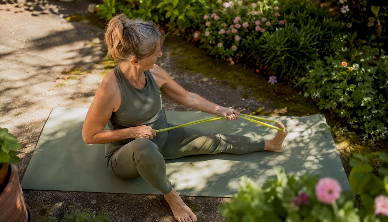 Middle-aged woman exercising with resistance bands