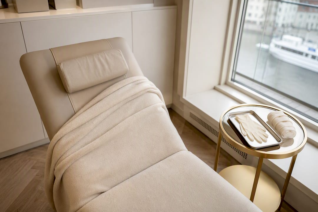 Elegant återhämtningsrum på klinik med bekväm vilofåtölj och allt för sårvård