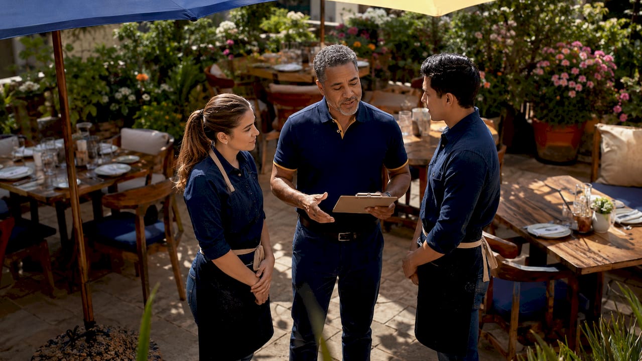 Manager discussing terrace seating with restaurant staff