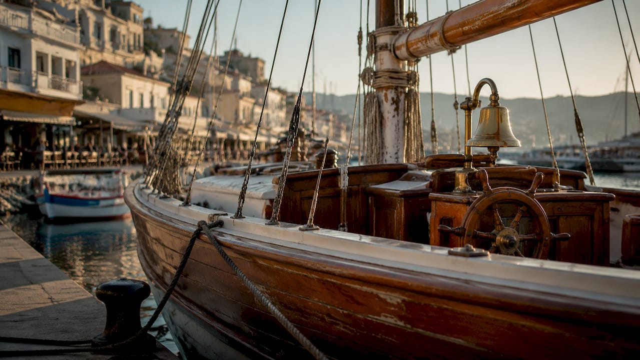 Close-up of ship hull, mast, and bell