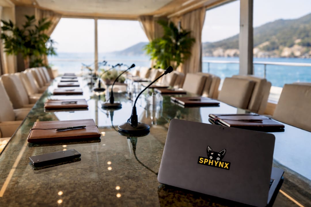 Conference table setup with tech on yacht