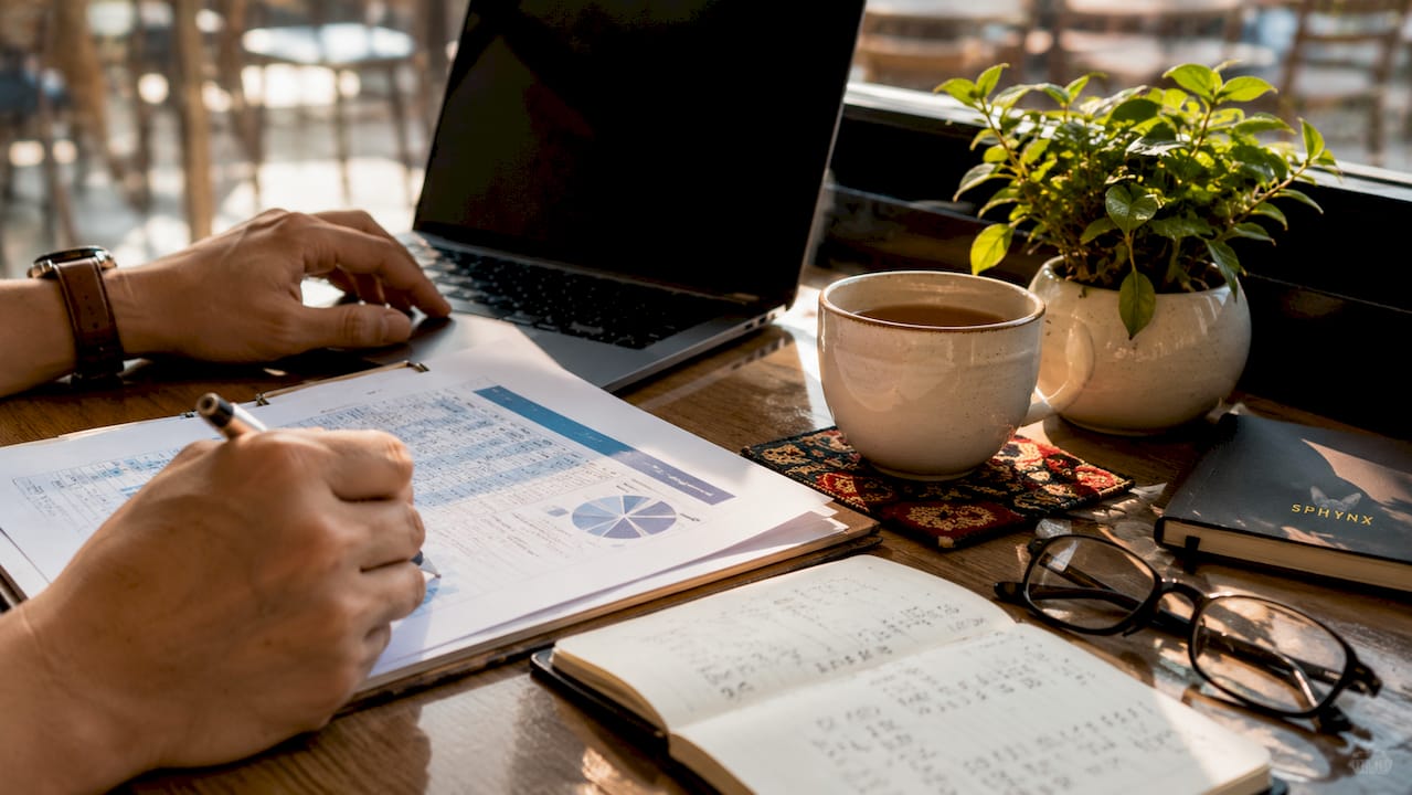 Overhead view of budget planning documents and calculator