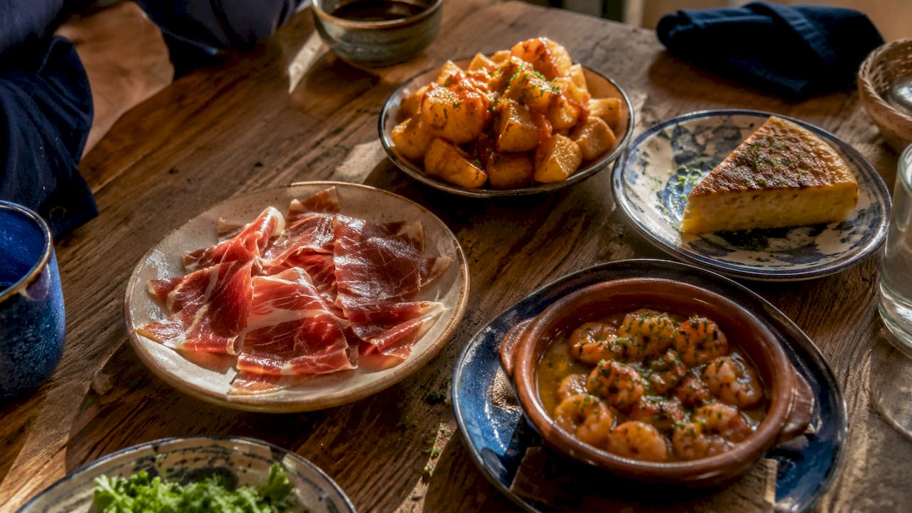 Classic Spanish tapas dishes on wooden table