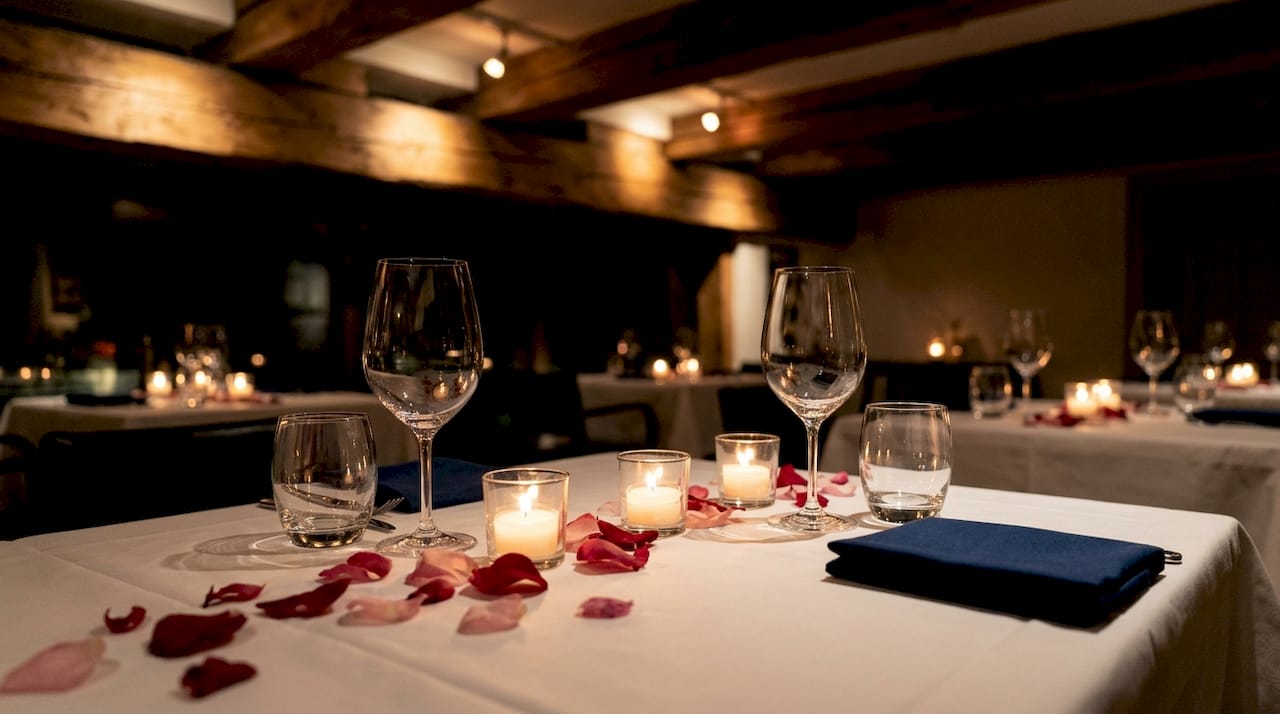 Dimly lit romantic restaurant interior with candlelight