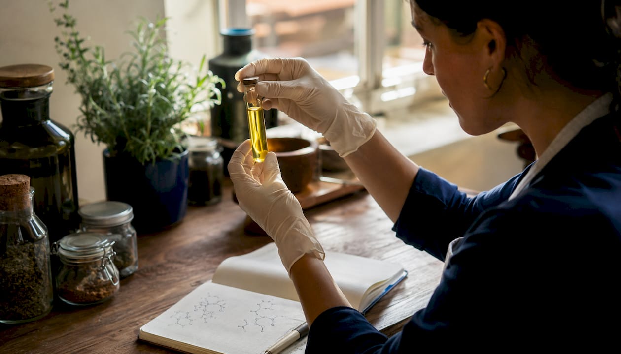 Researcher analyzing olive oil sample in lab