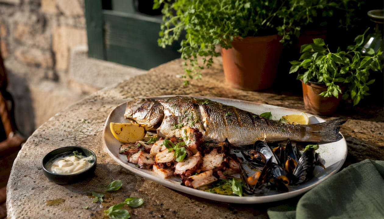 Overhead seafood platter with grilled fish and shellfish