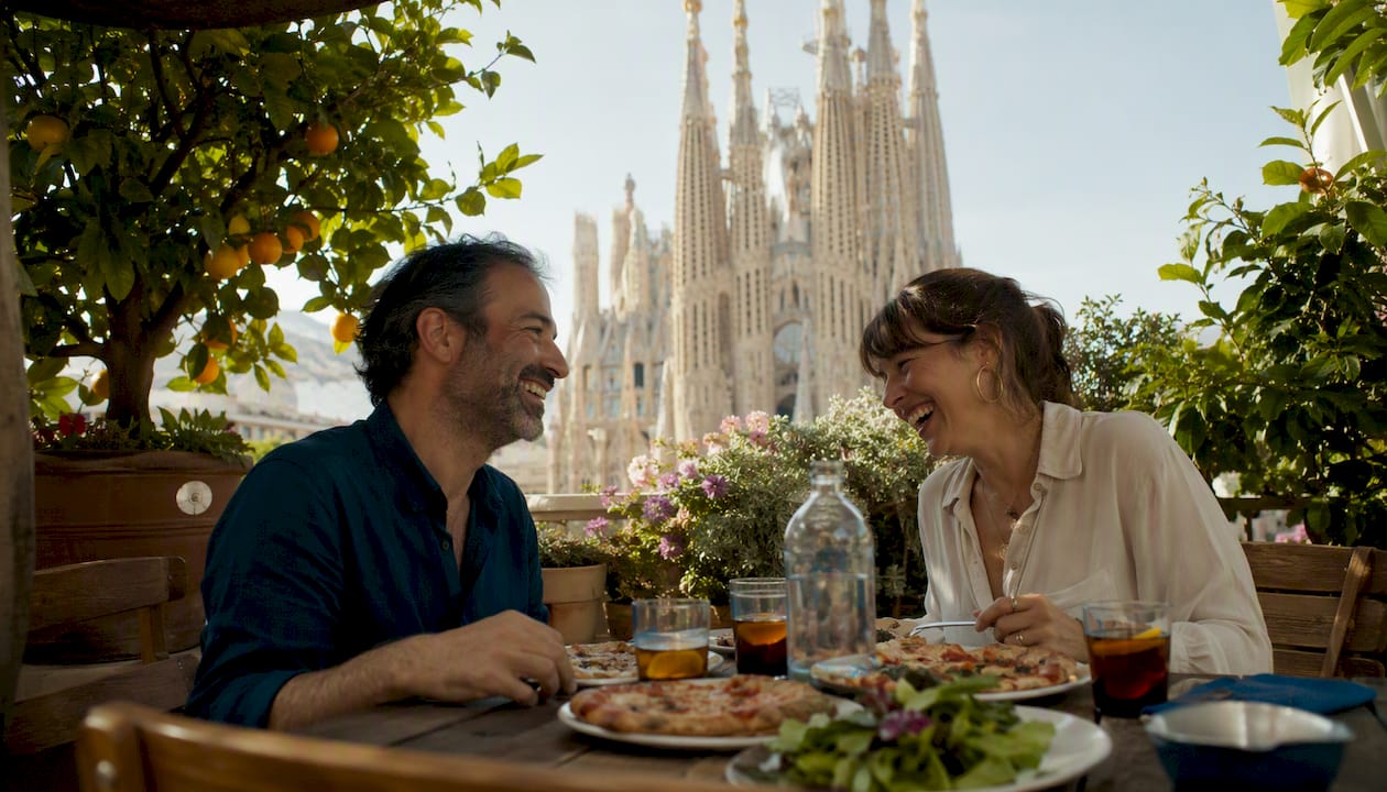 Couple dining on terrace with view of Sagrada Familia