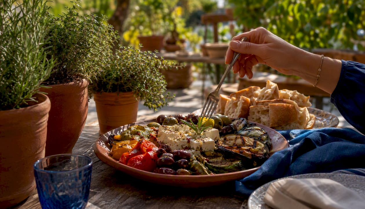 Close-up of Mediterranean plated dish with hand