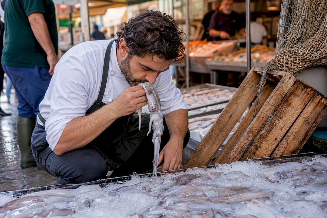 Chef checking squid freshness at market
