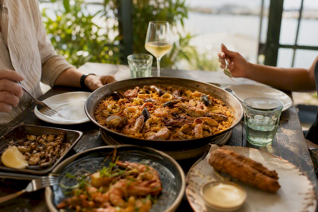 Shared arroz seafood rice dish on wooden table