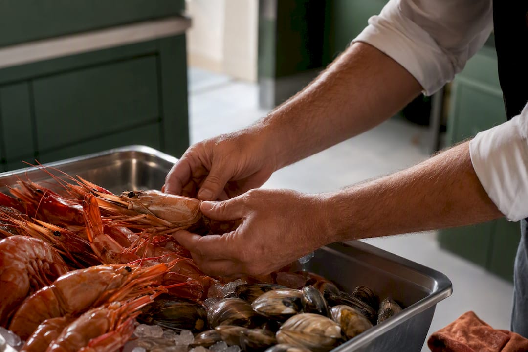 Hands checking fresh shellfish delivery