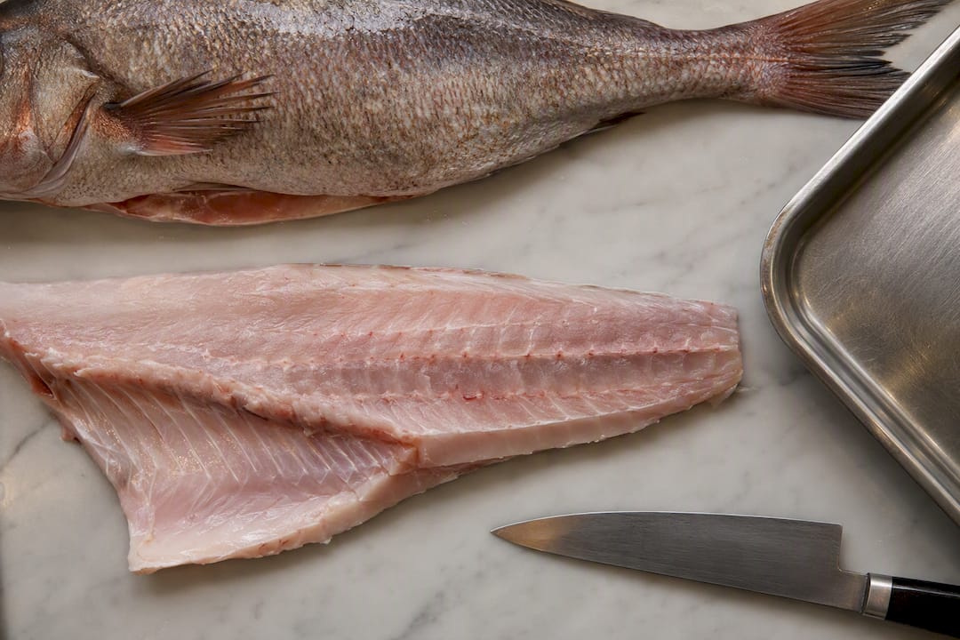 Whole fish beside boned fillet