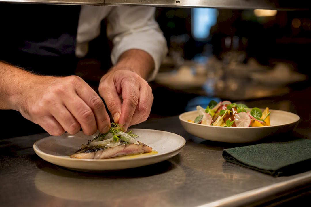 Chef preparing separate group menu adaptations