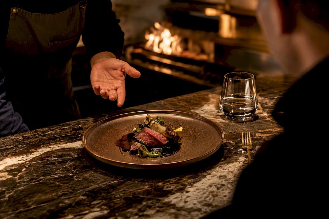 Server explaining a tasting menu course