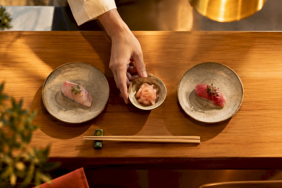 Pickled ginger between sushi tasting plates