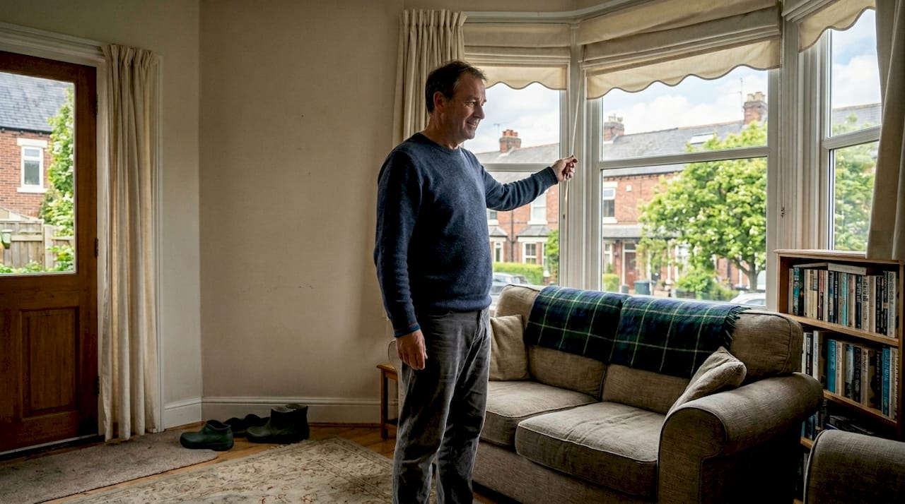 Man adjusting awning in Yorkshire living room