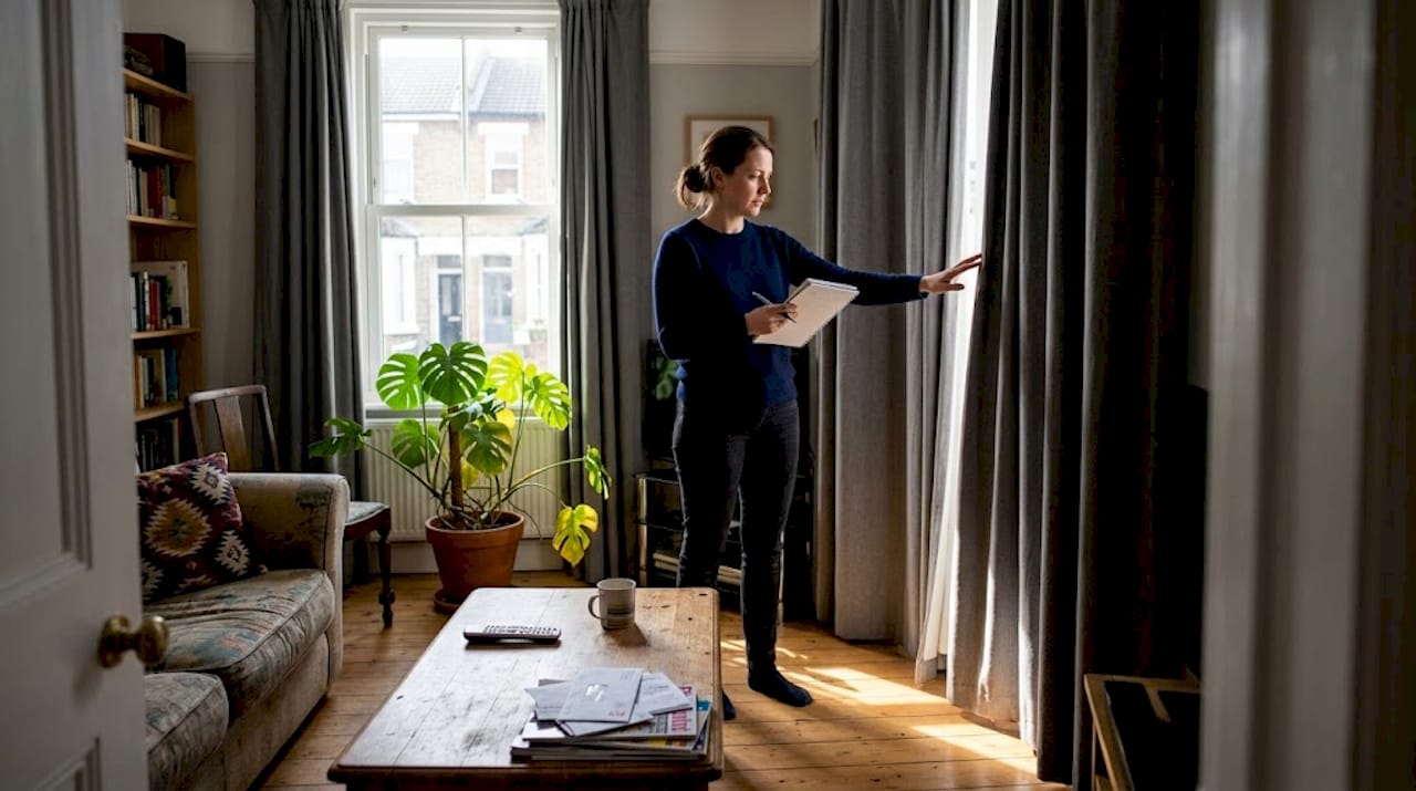 Homeowner checking living room for heat