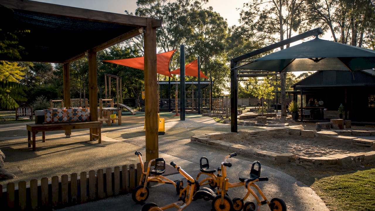 Playground with various shade structures under sunlight