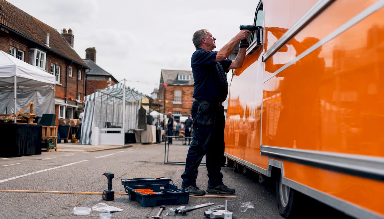 Technician installing awning on food truck side