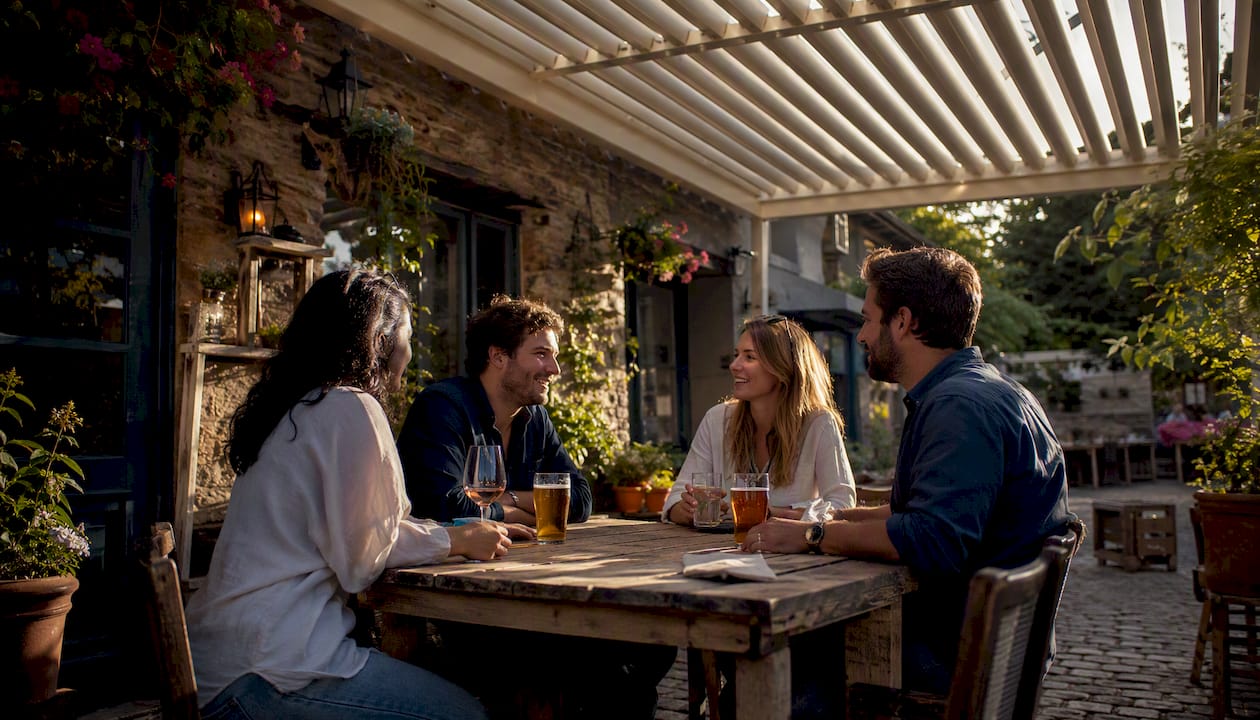 Pub terrace shaded by louvred pergola with seated patrons