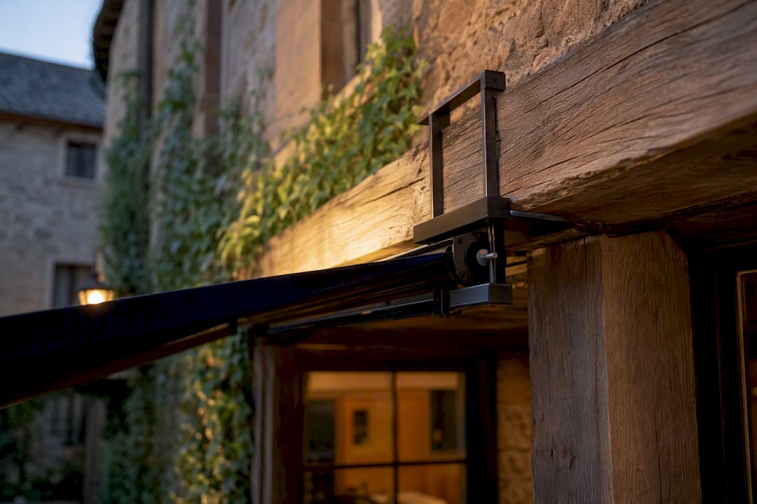Non-invasive awning clamp on heritage building