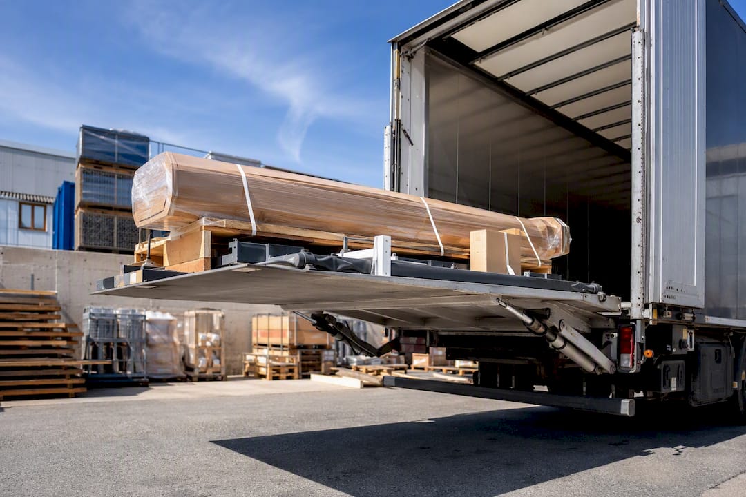 Loading awning parts onto delivery truck tail lift