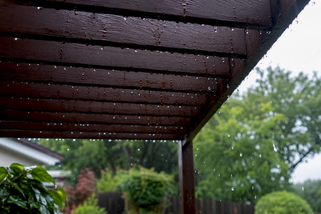 Rain droplets hitting pergola metal roof