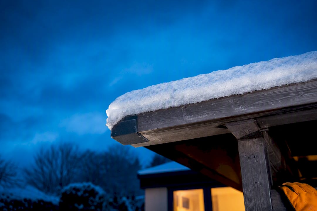 Snow-covered roof structure in a UK garden