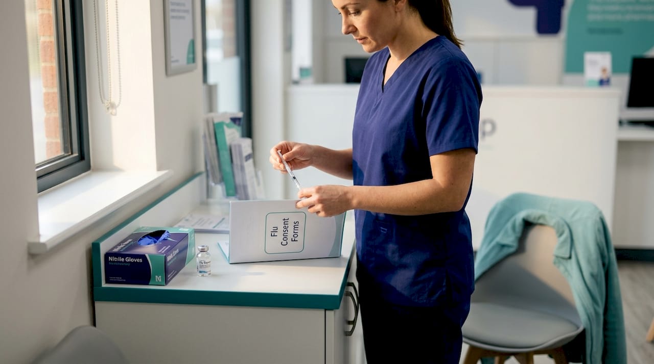 Nurse preparing flu vaccine injection