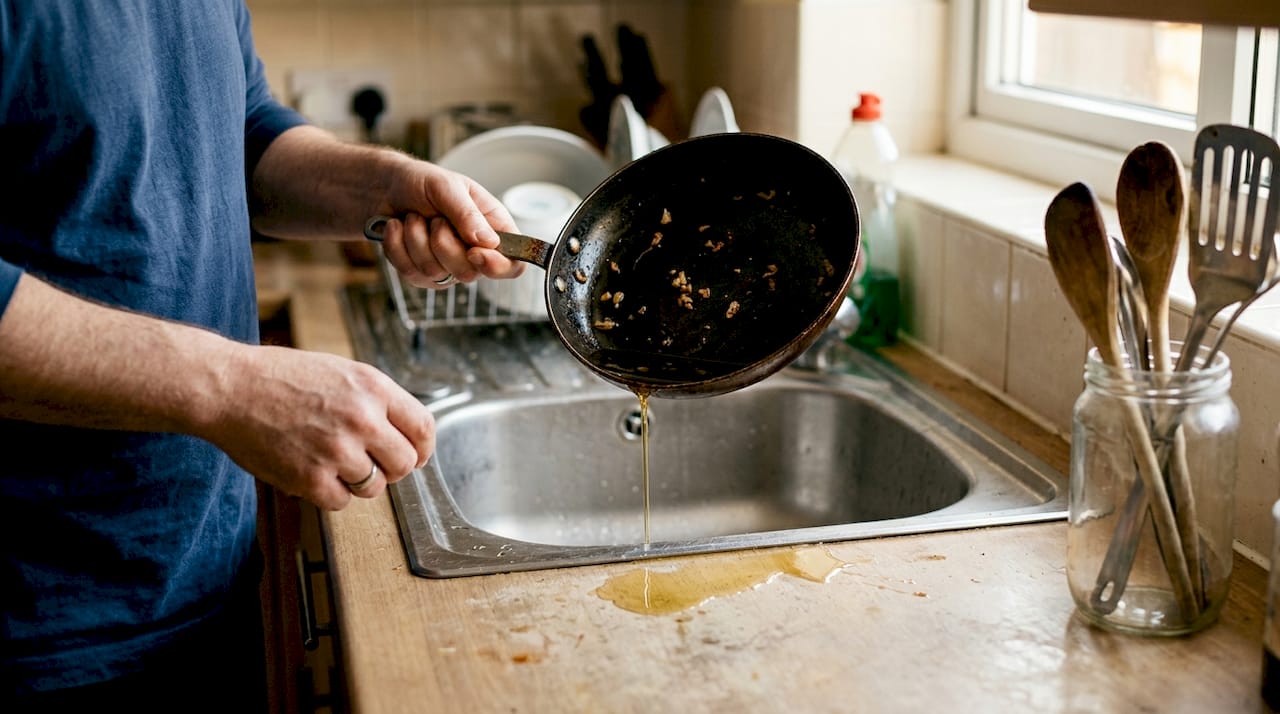 Cooking oil poured into kitchen drain