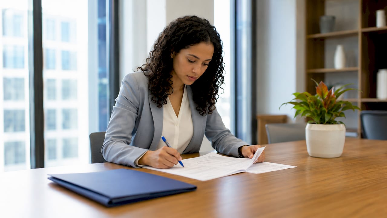Hands reviewing second passport eligibility documents