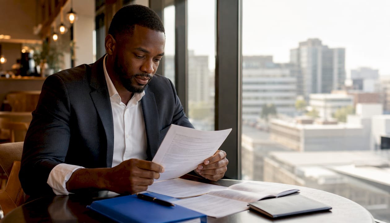 Businessman reviewing passport validity rules at desk