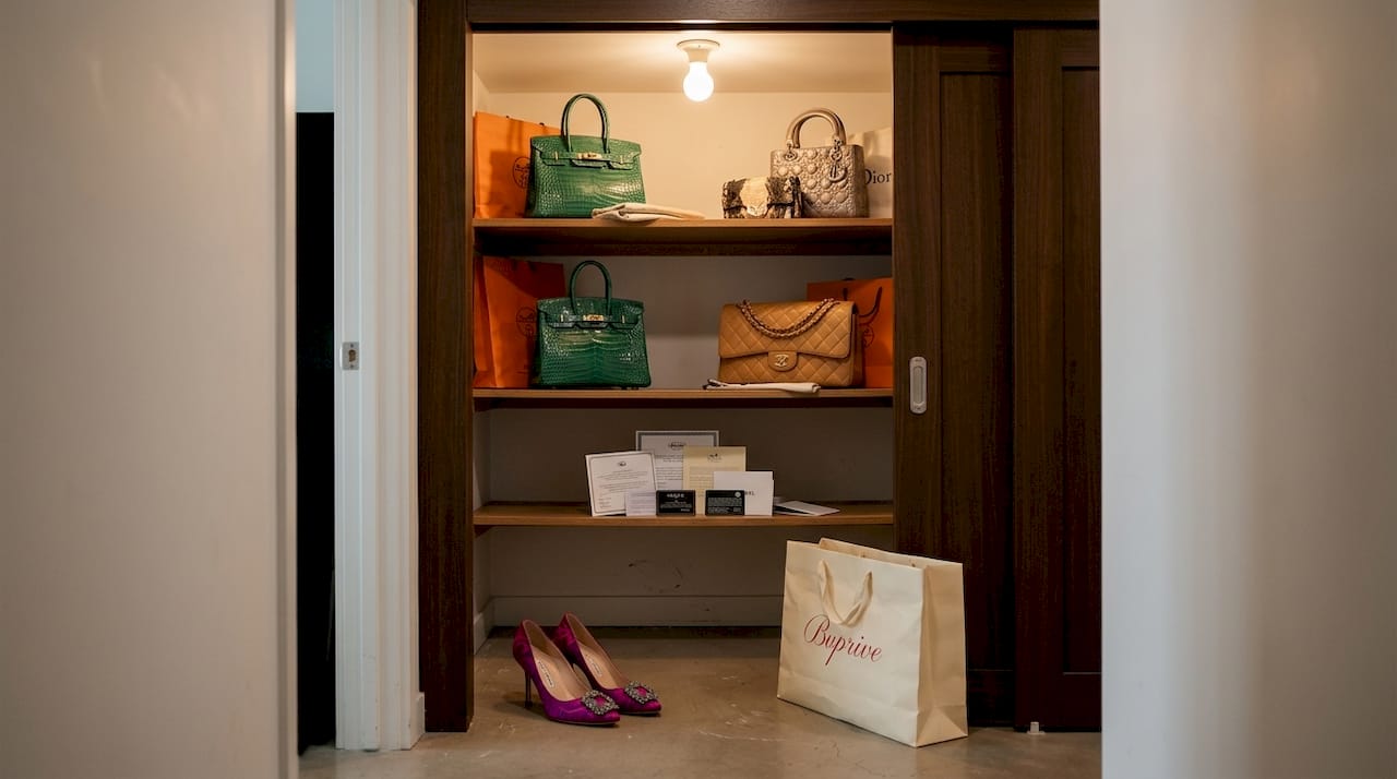 Rare designer handbags organized on closet shelves