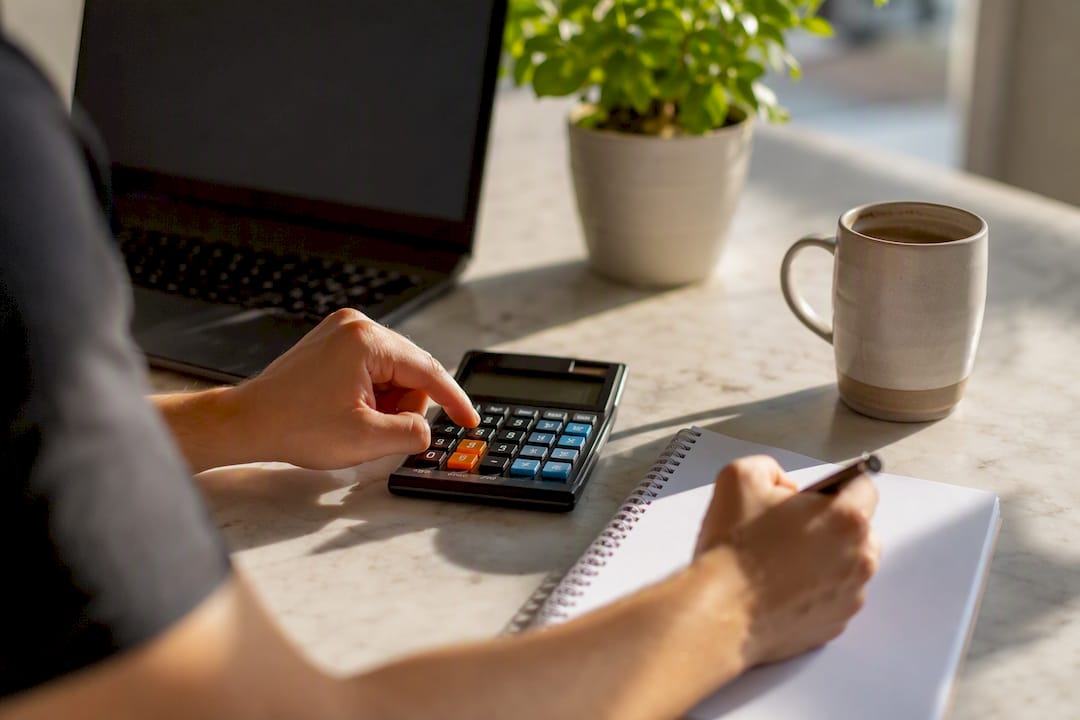 Indicateurs performance boutique en ligne : les 8 à suivre 1 Mains en train de calculer la valeur vie client