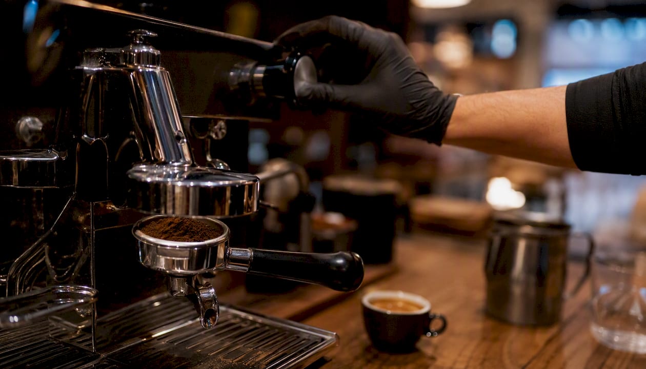 Detail of espresso machine portafilter and hand adjusting pressure
