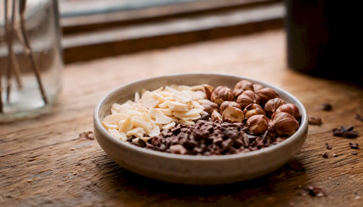 Roasted cocoa nibs and assorted nuts close-up
