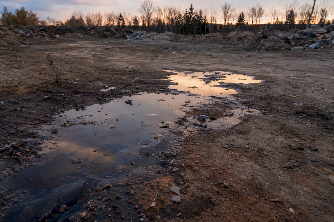 Contaminated ground with spilled vehicle fluids