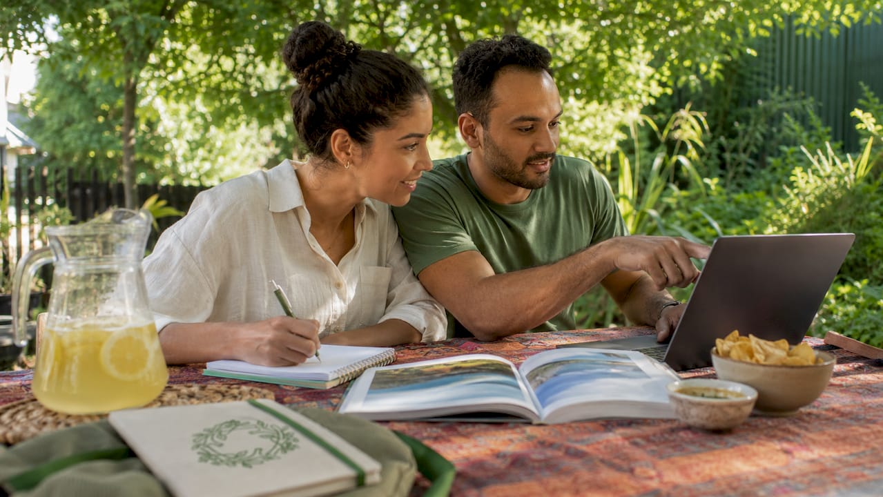 Couple planning vacation rental together at table