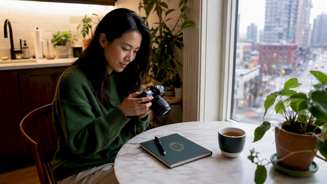 Woman reviewing Airbnb listing photos in living room