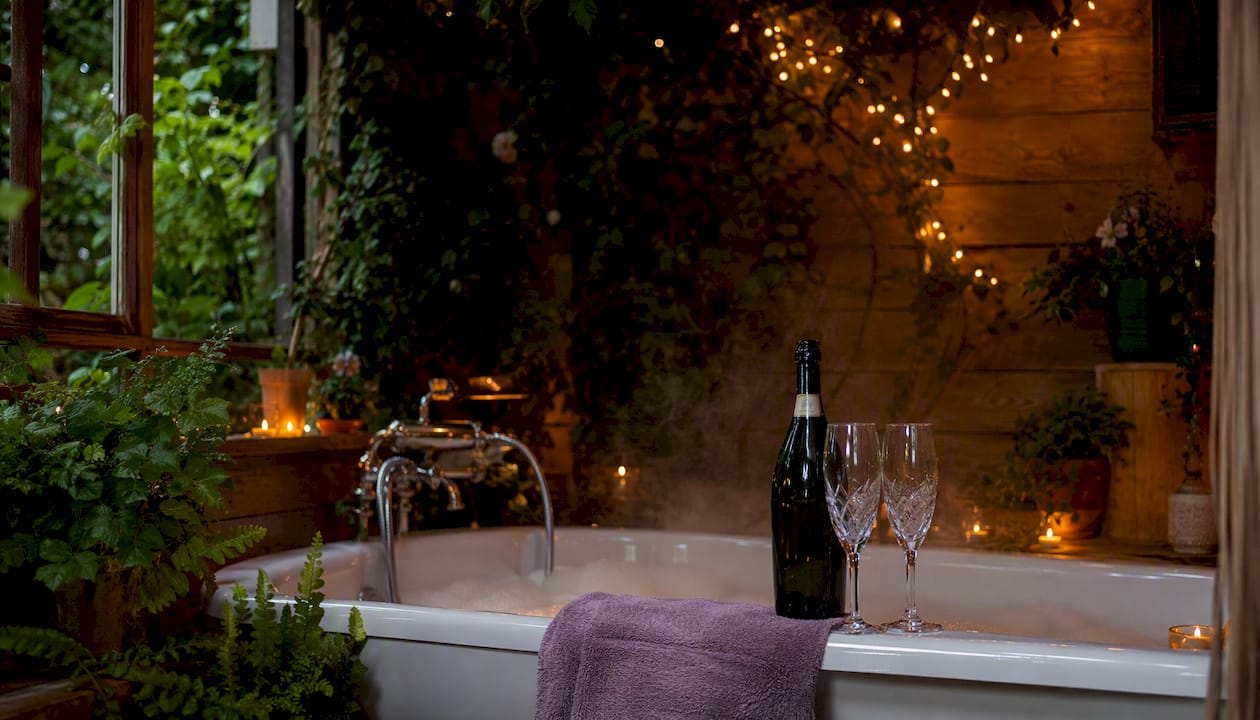 Candlelit bath with wine in Airbnb bathroom