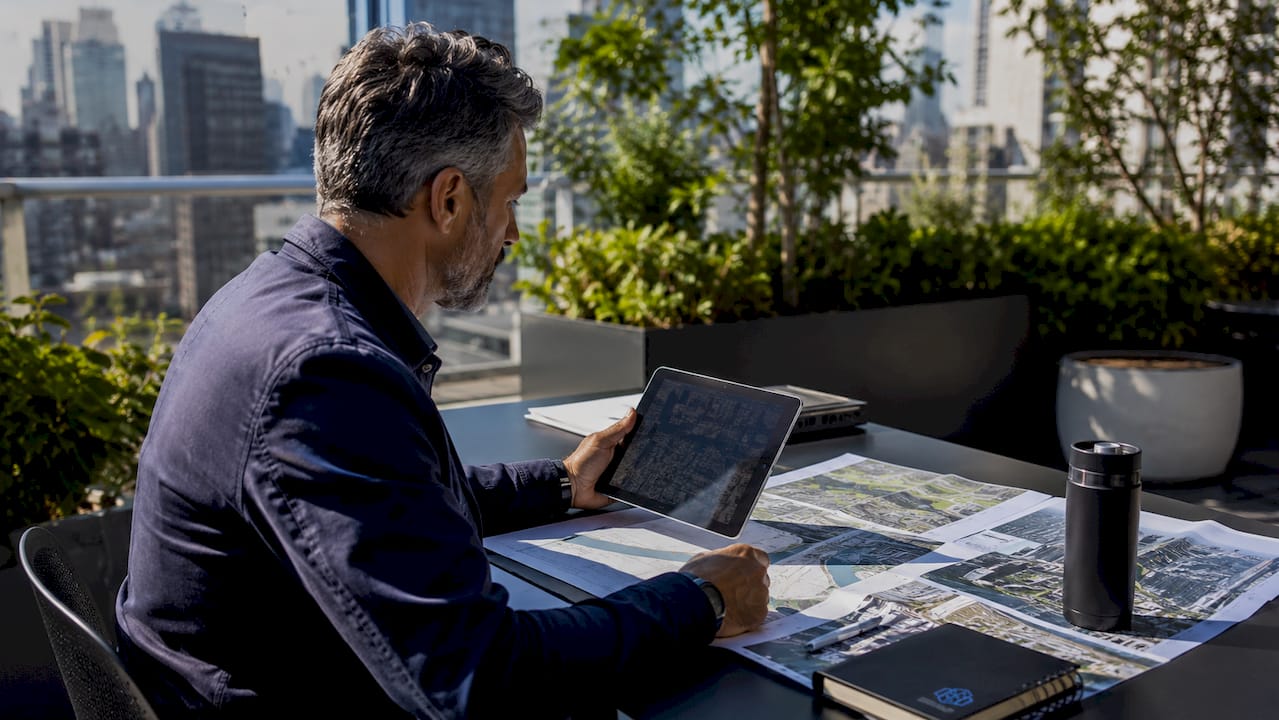 Urban planner reviewing digital and paper city maps