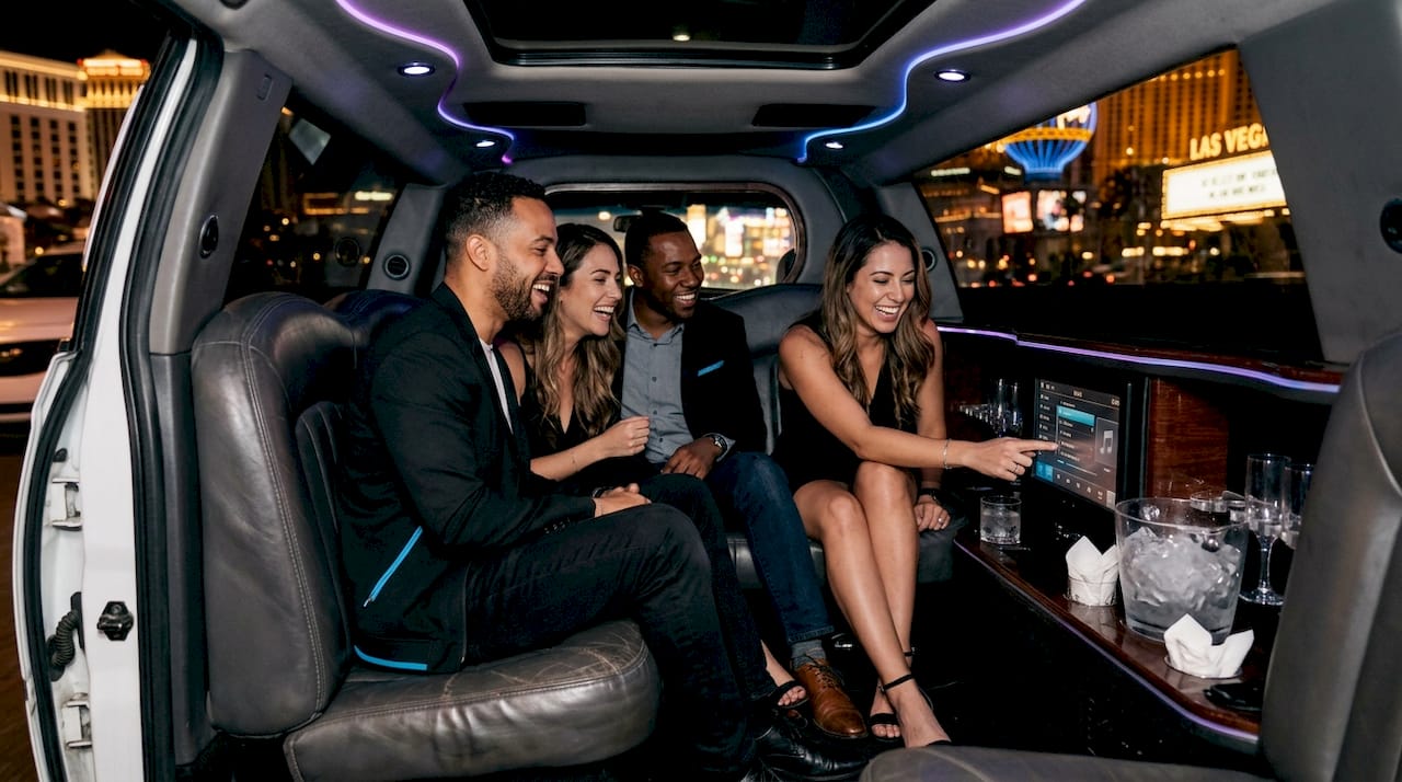 Friends enjoying limo interior with amenities