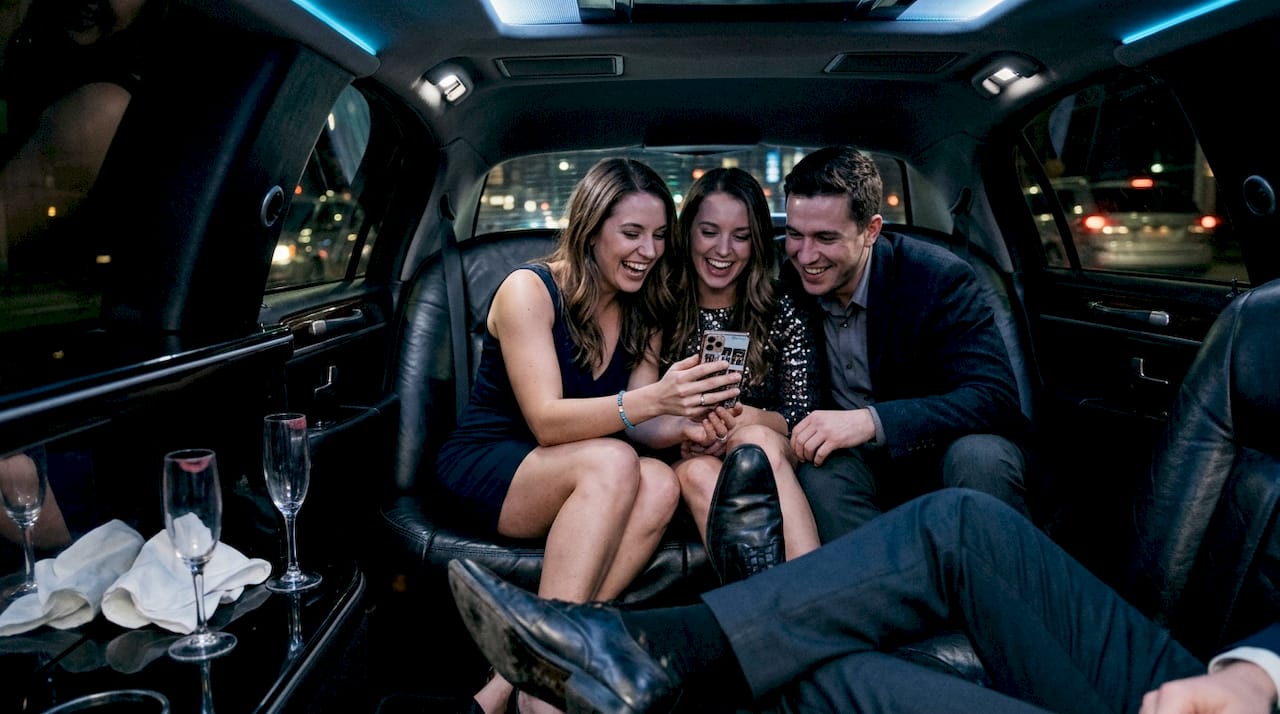 Friends sharing celebration inside stretch limo