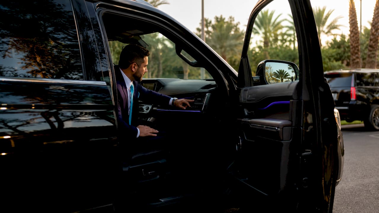 Chauffeur preparing luxury vehicle interior