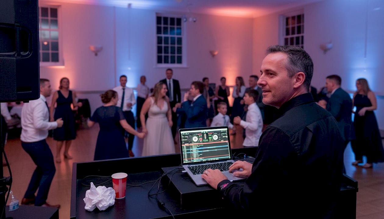 DJ and dancing wedding guests in parish hall
